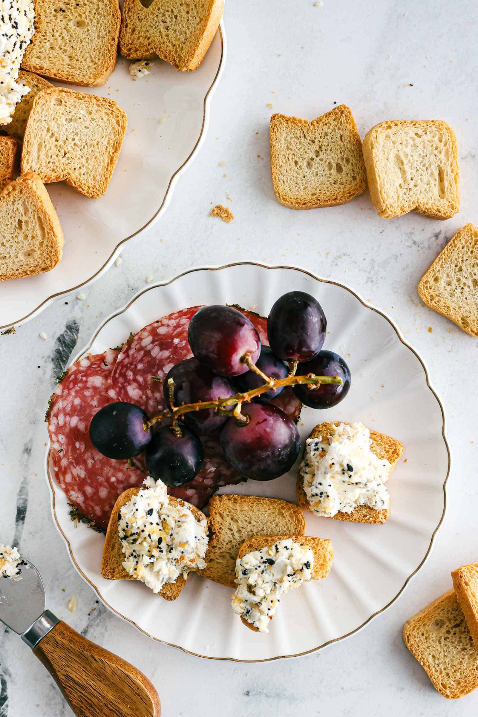 Grapes, salami and cheese spread on crackers