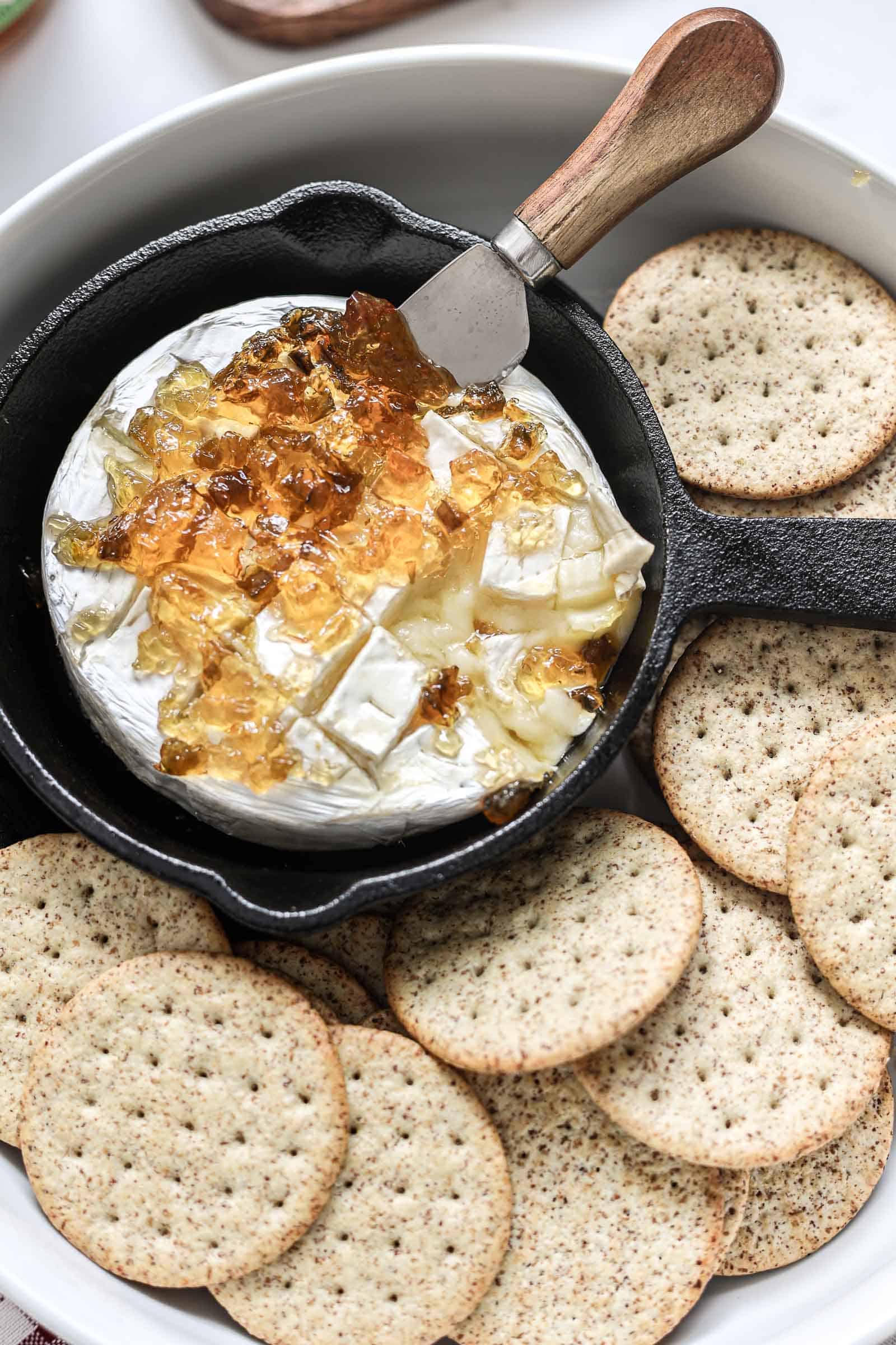 Baked Brie with Red Pepper Jelly Appetizer in serve wear. 