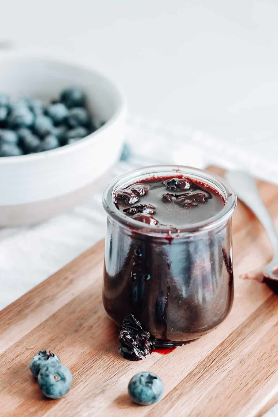 Blueberry lemon compote in a jar on a serving board.