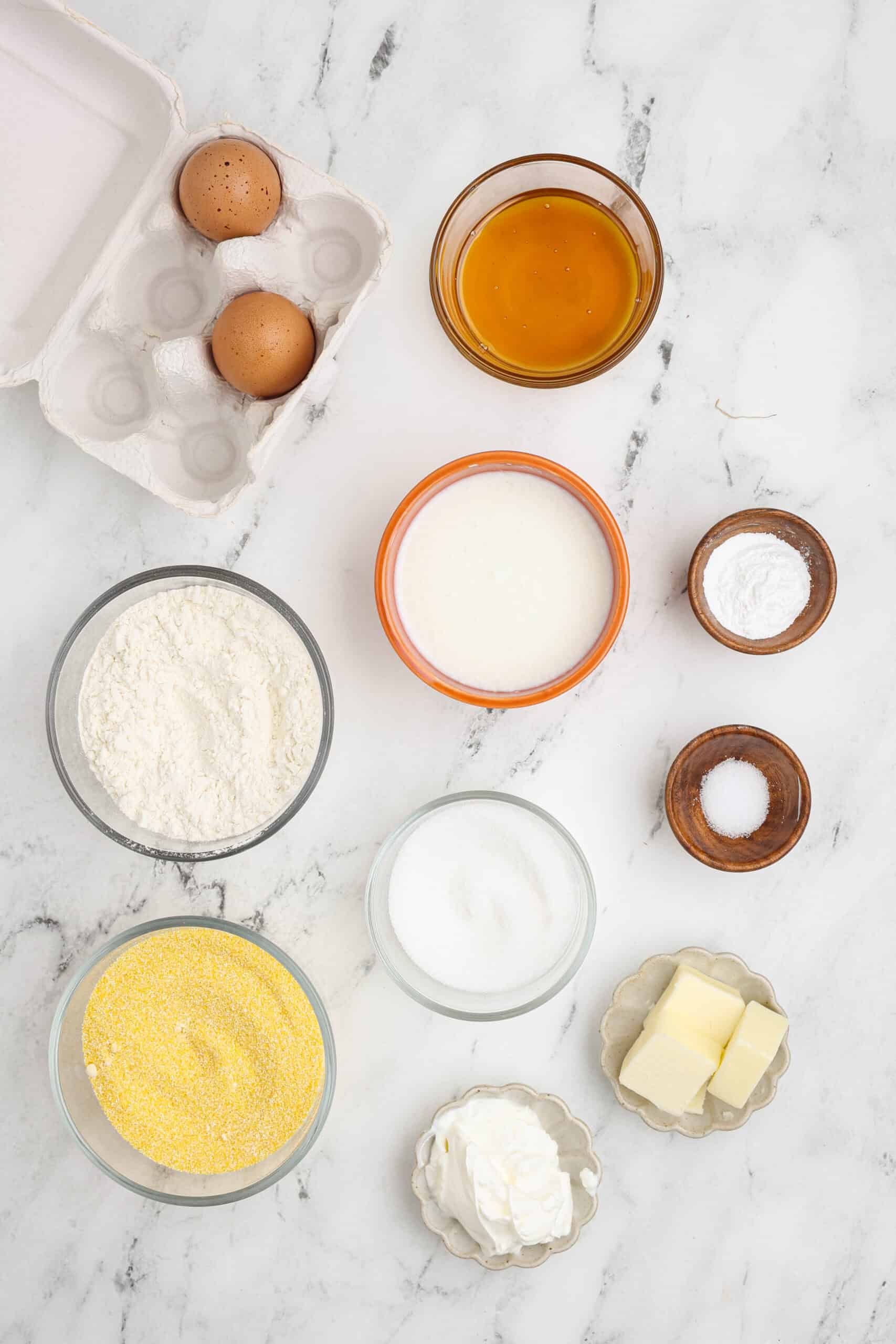 Honey cornbread muffins ingredients on a table.