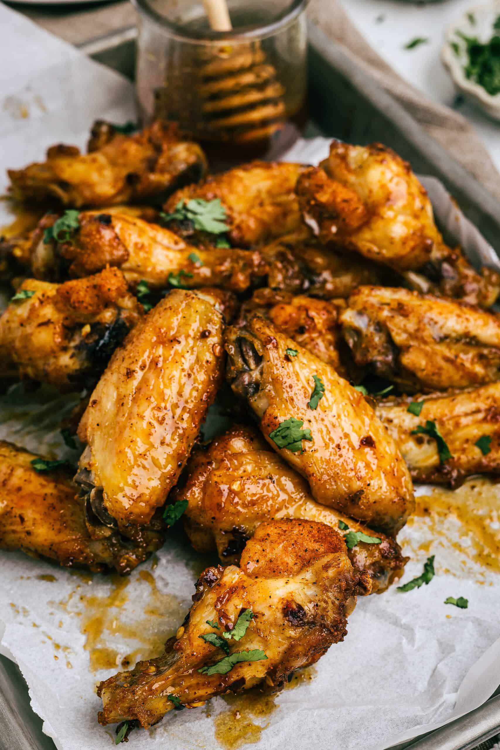 Crispy glazed chicken wings with herbs, served with dipping sauce.