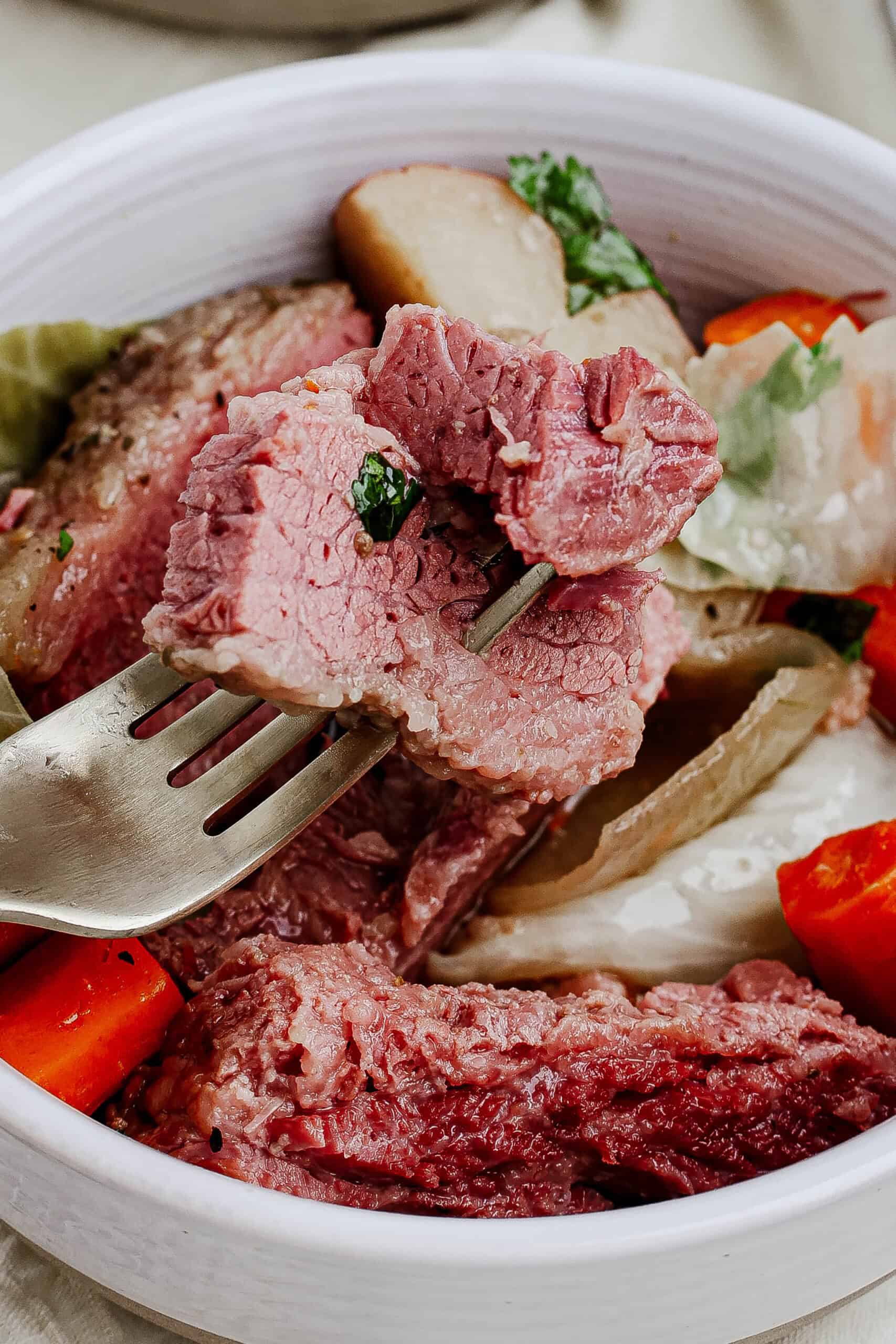 Close up of corned beef on a fork.