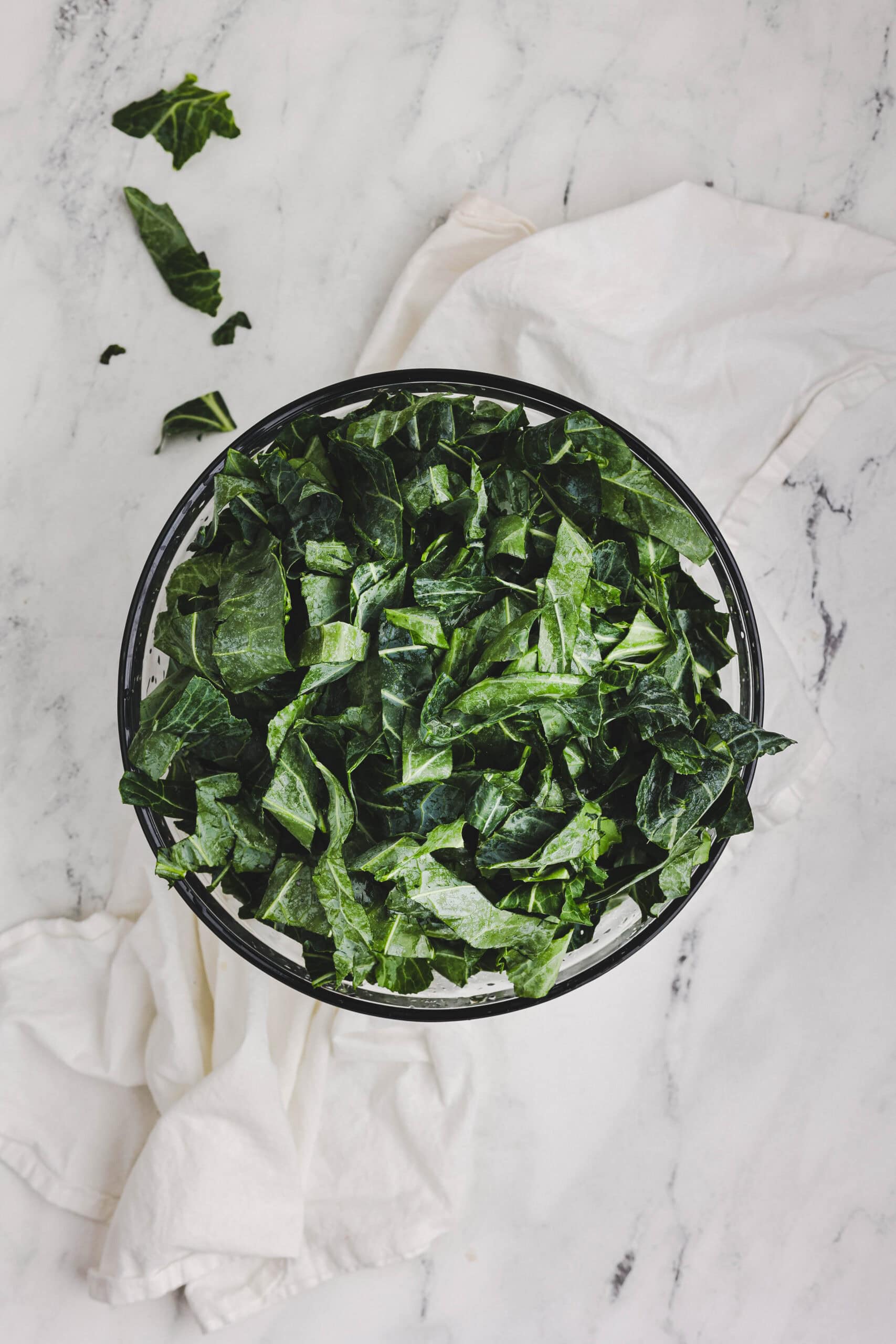 Fresh chopped collard greens in a bowl ready for cooking.
