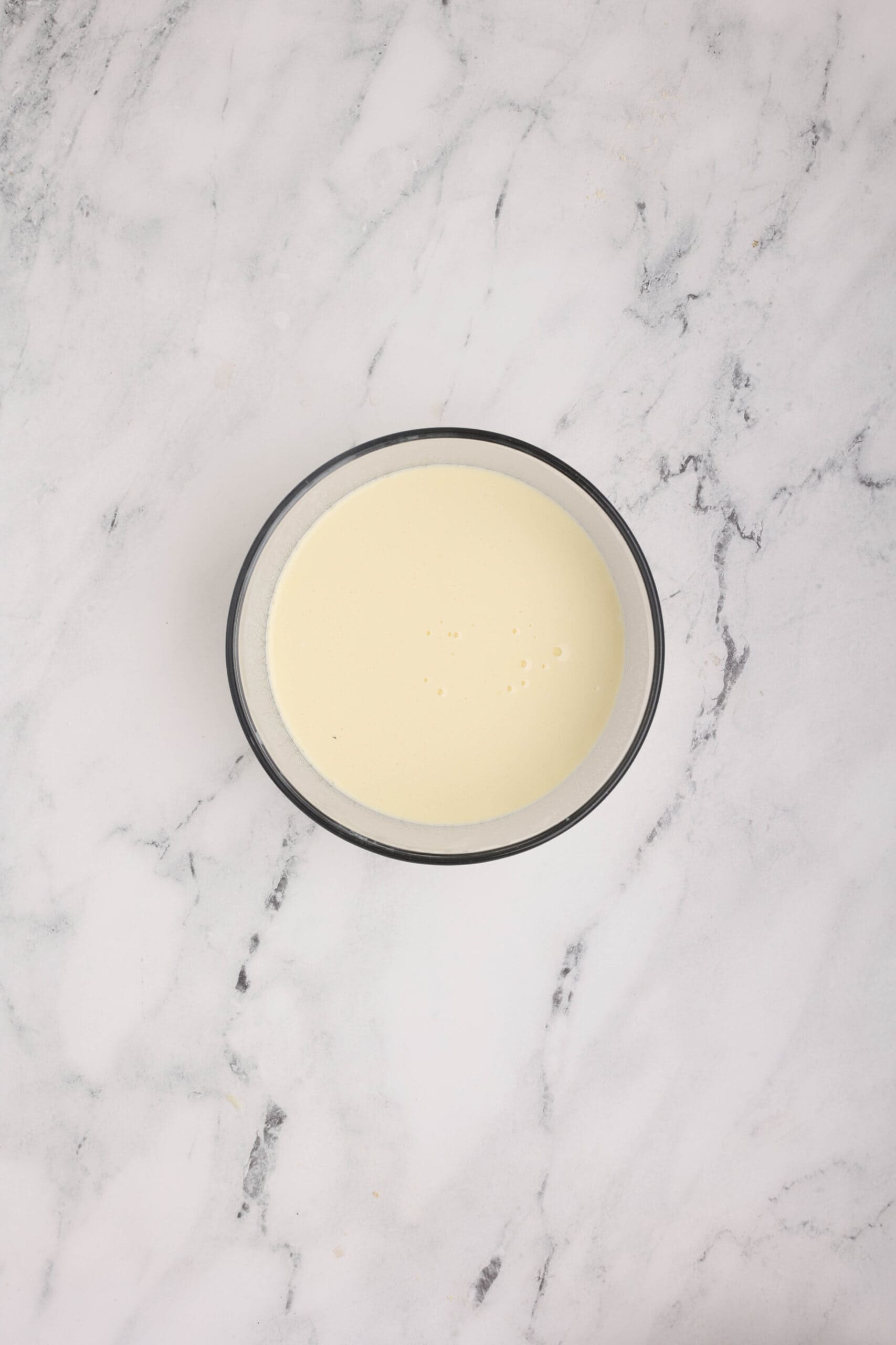 Milk and sour cream mixture prepared for cornbread batter.