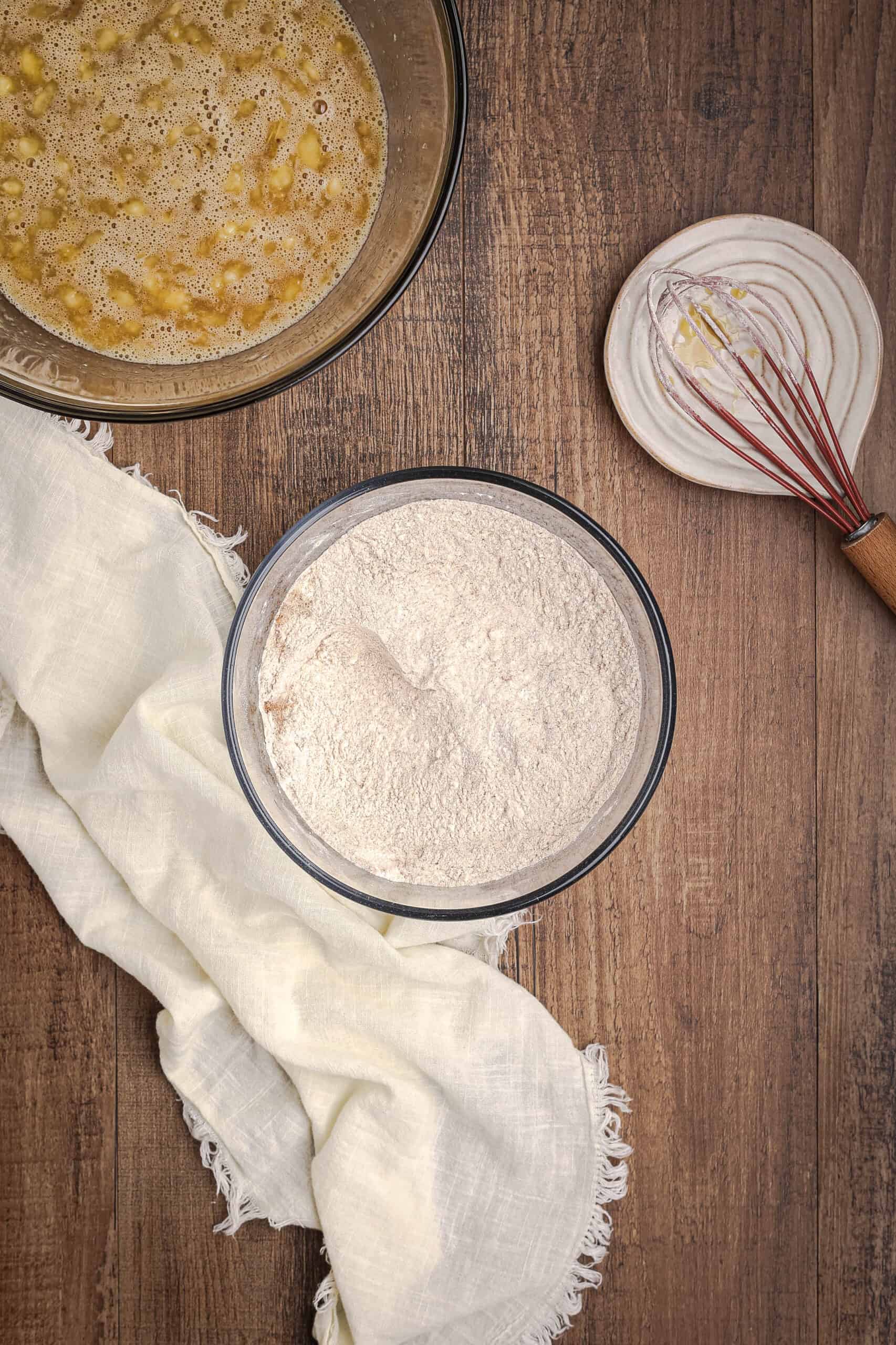 Dry ingredients including flour and spices in a bowl ready to be mixed into banana bread batter